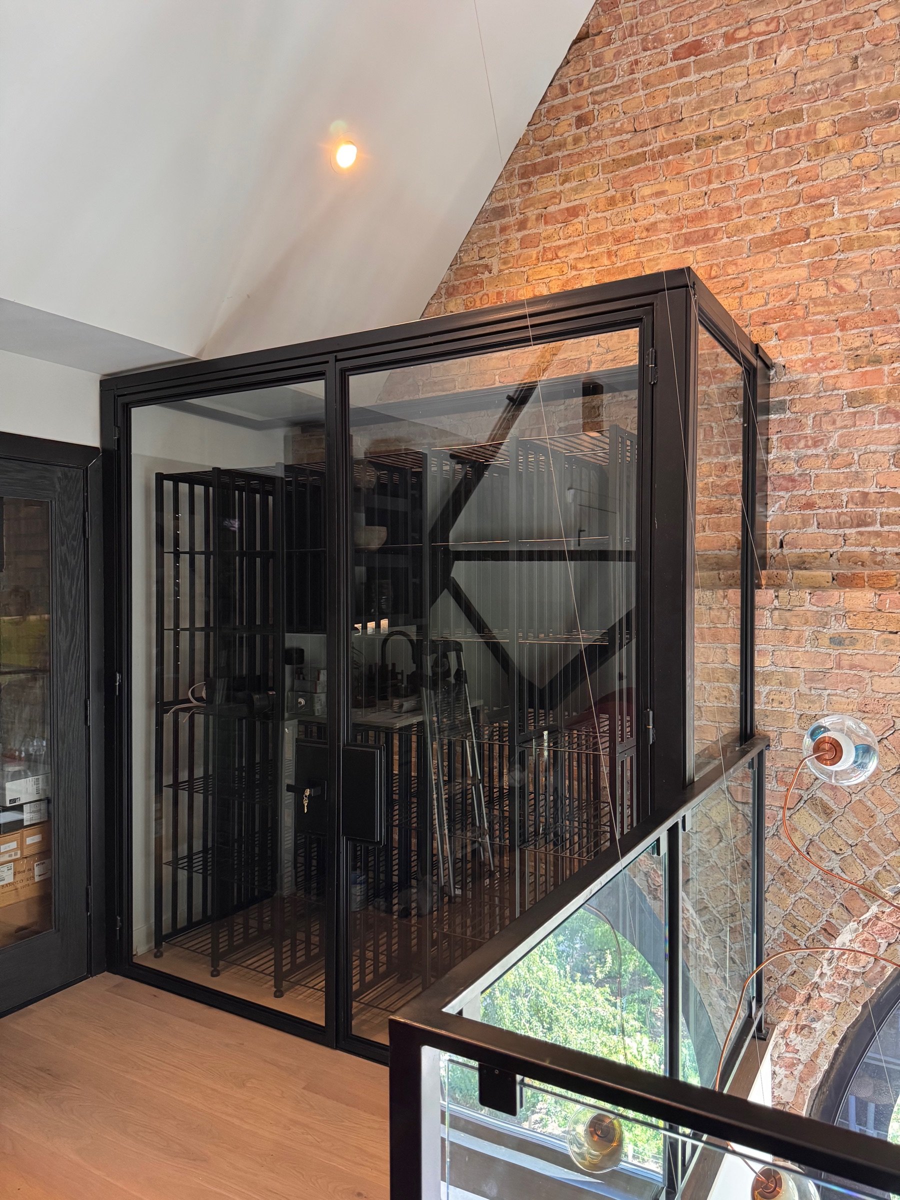 Bronze-finished steel frame detail on the wine cellar doors