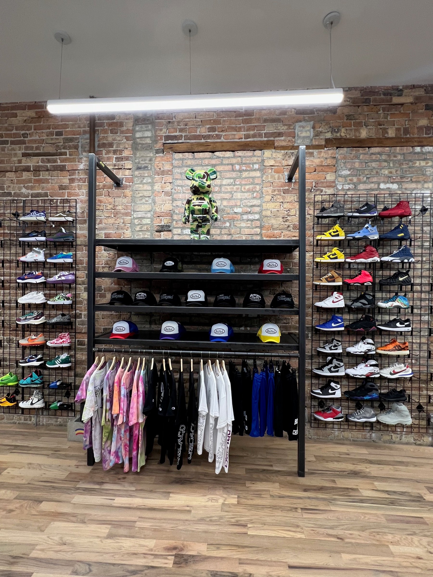Centered view of the sneaker display wall and custom black steel fixture system