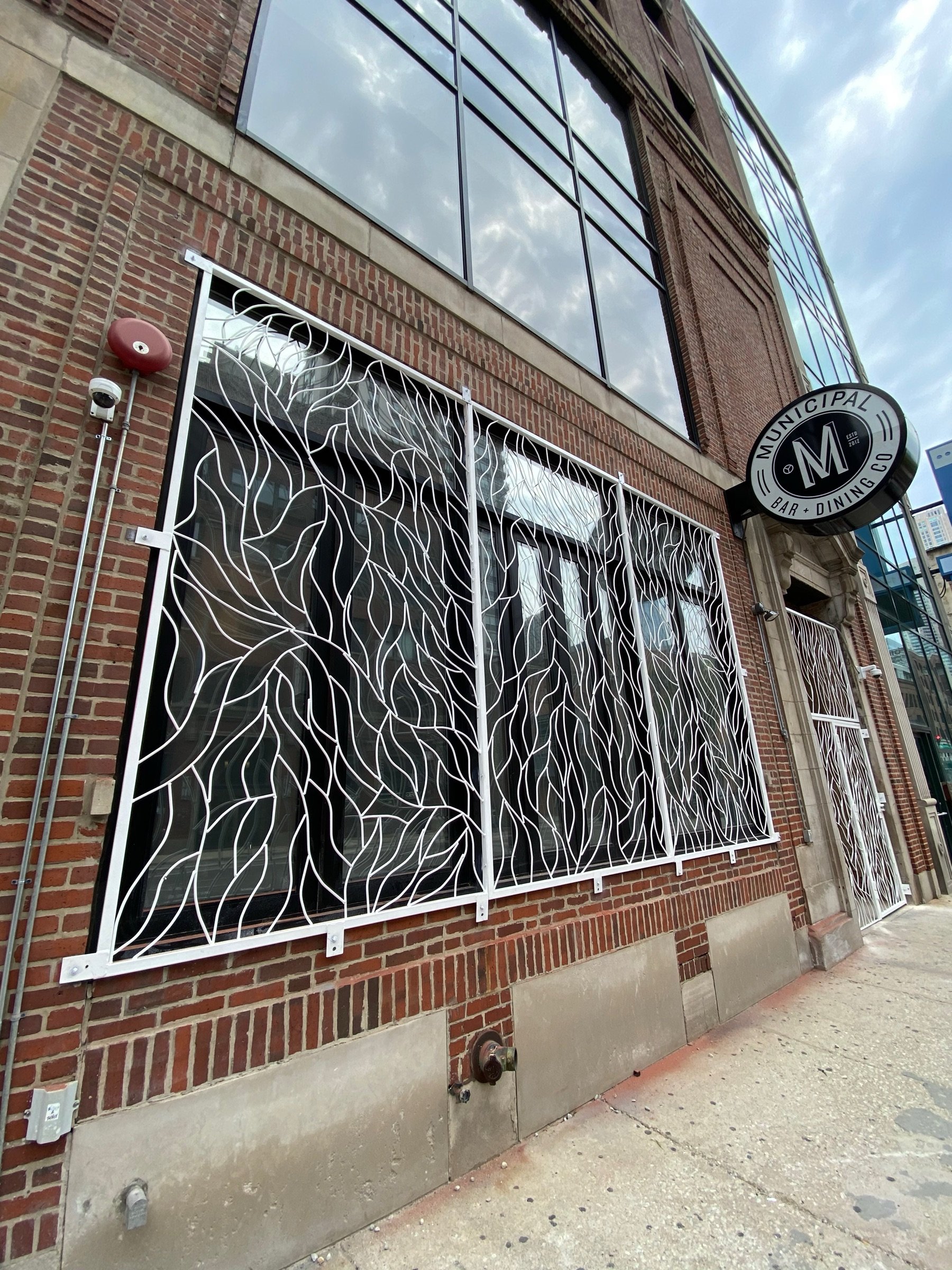 Moca storefront with hand-forged vine-pattern facade spanning the street-facing windows and entry