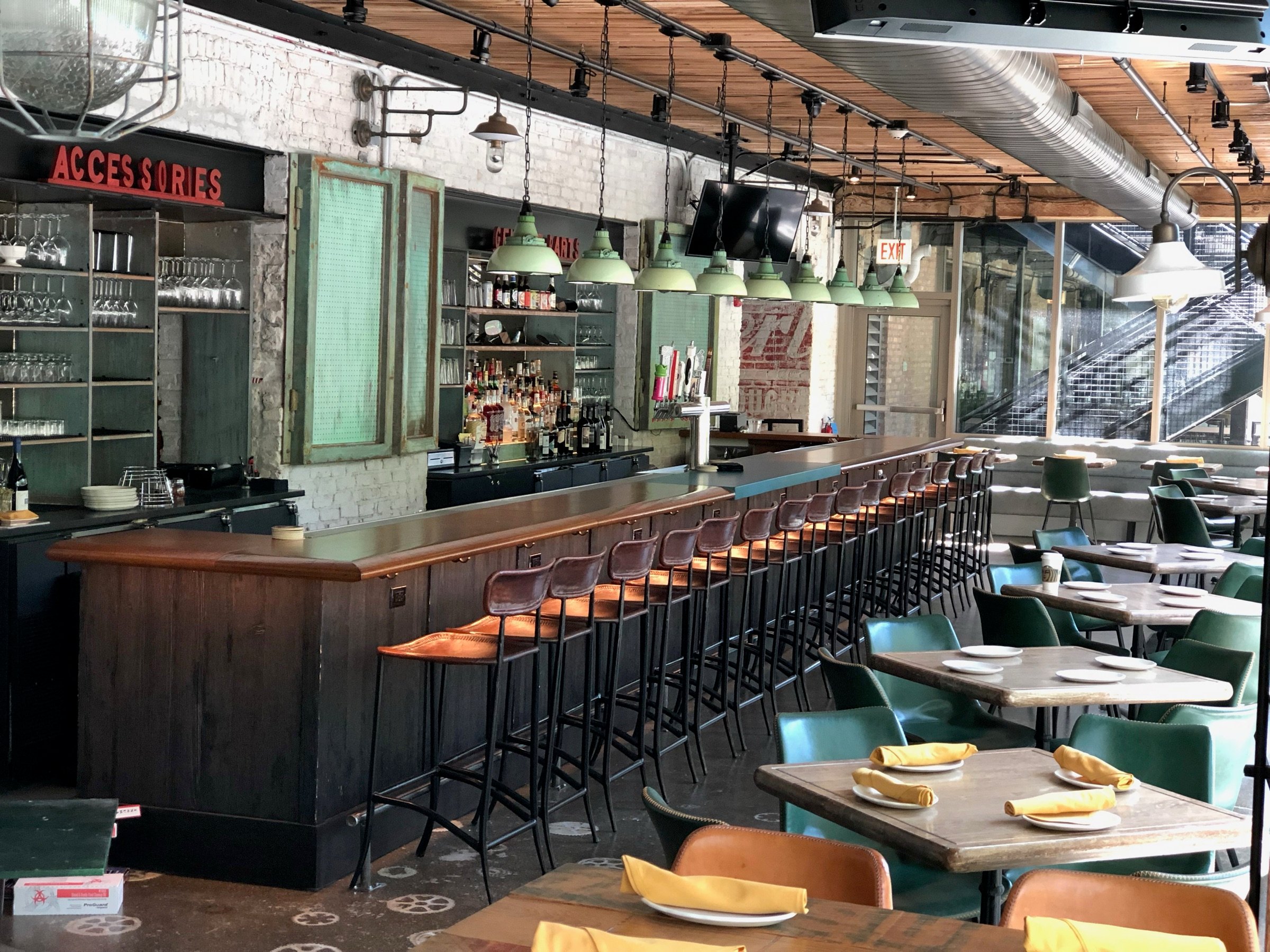 Finished Roberts Pizza dining room with custom steel partitions, upholstered banquettes, and warm industrial finishes