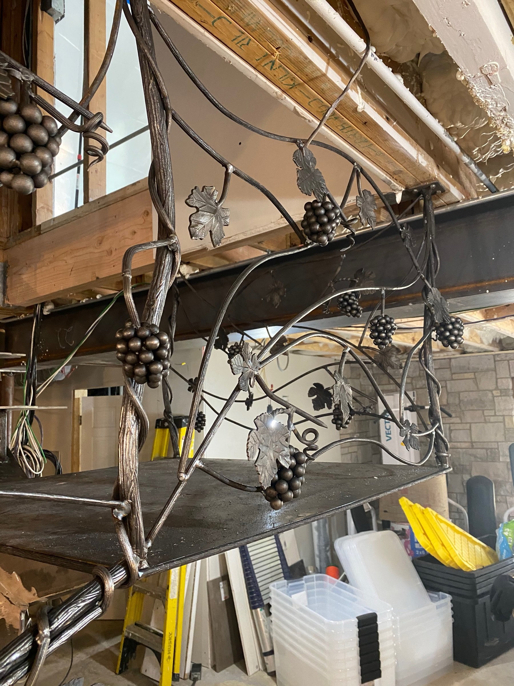 Breuder's sculptural vine stairwork with forged grapes and leaves