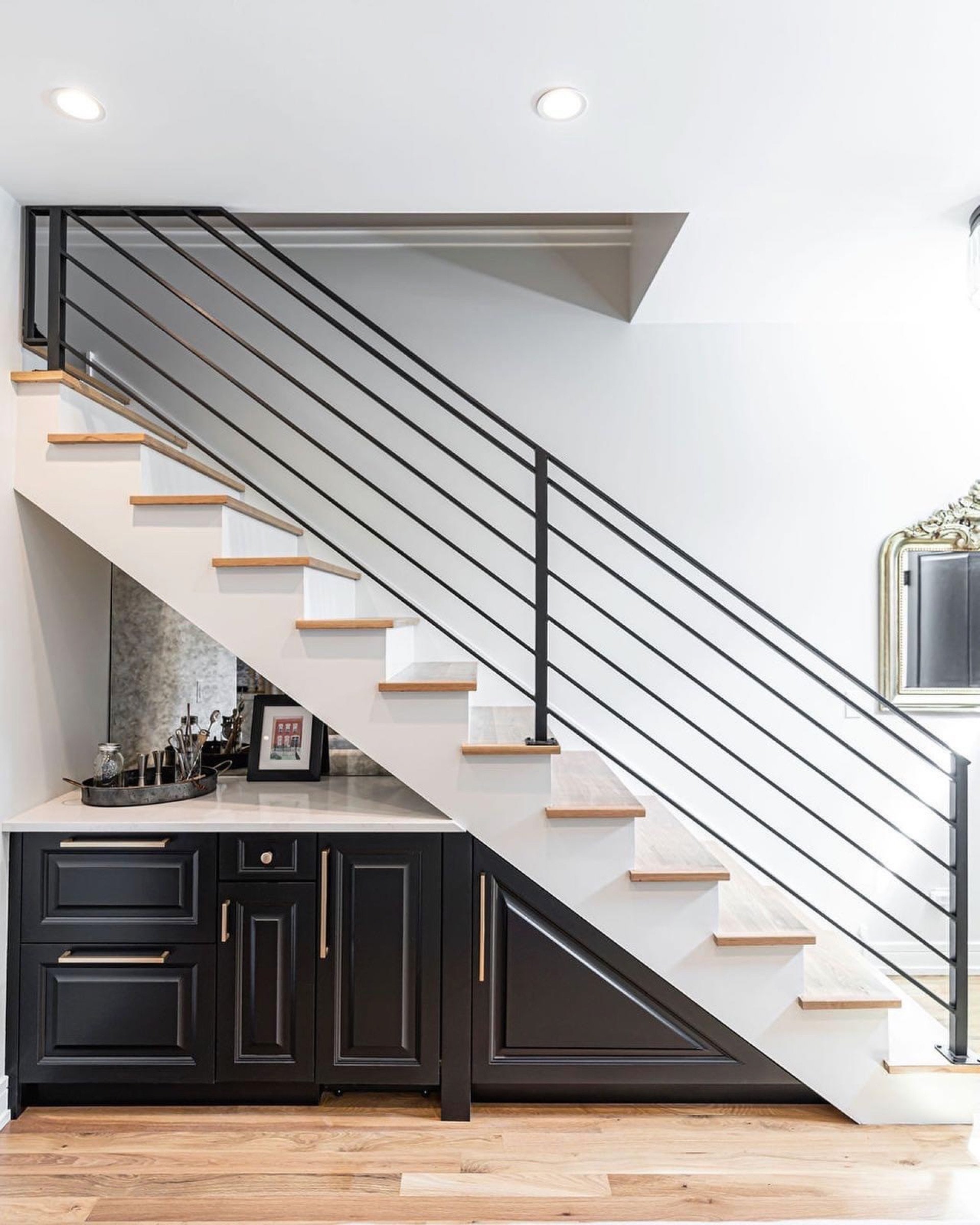 Horizontal-rod stair railing with a custom wet bar built into the space below