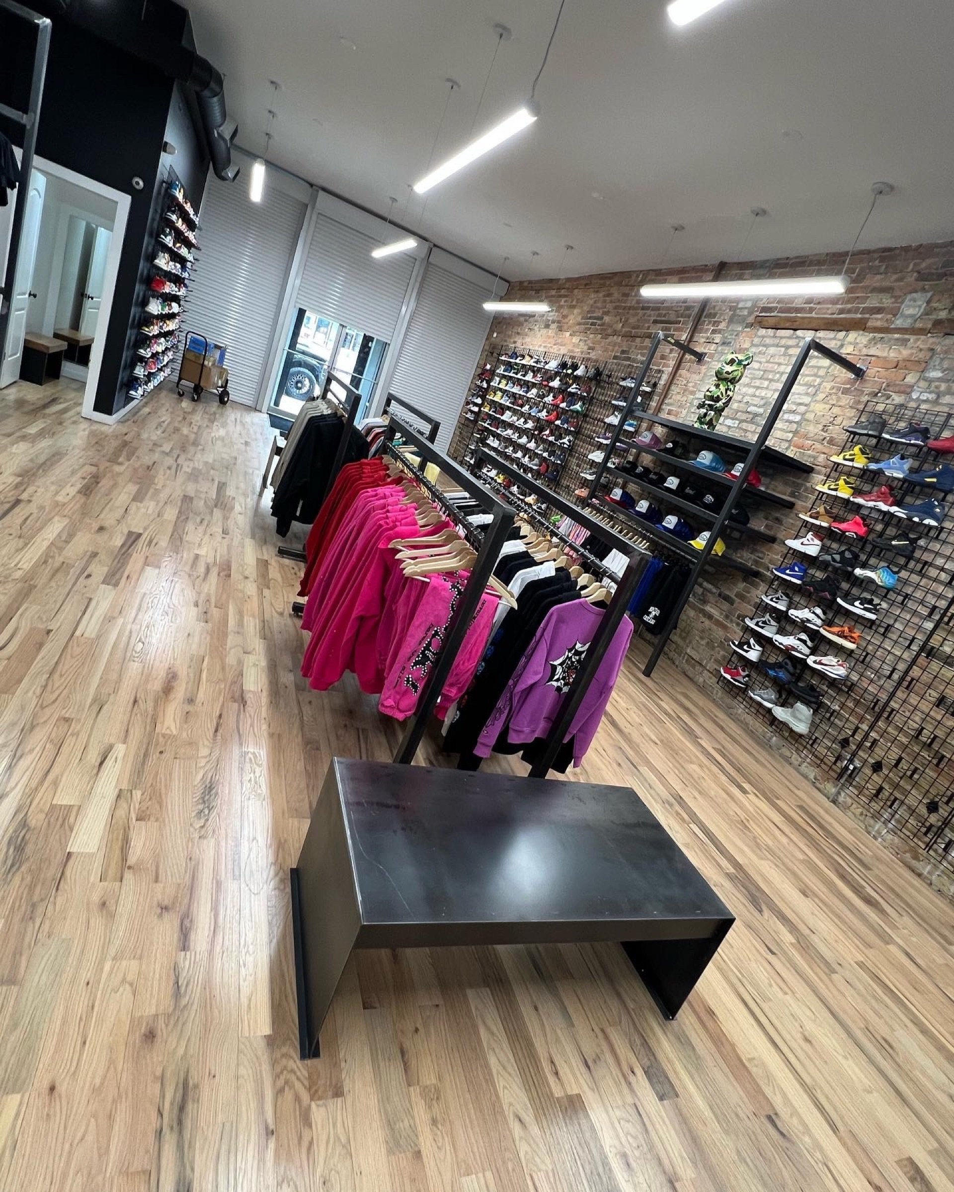 Perspective view across the open sales floor toward the Boneyard counter and feature wall