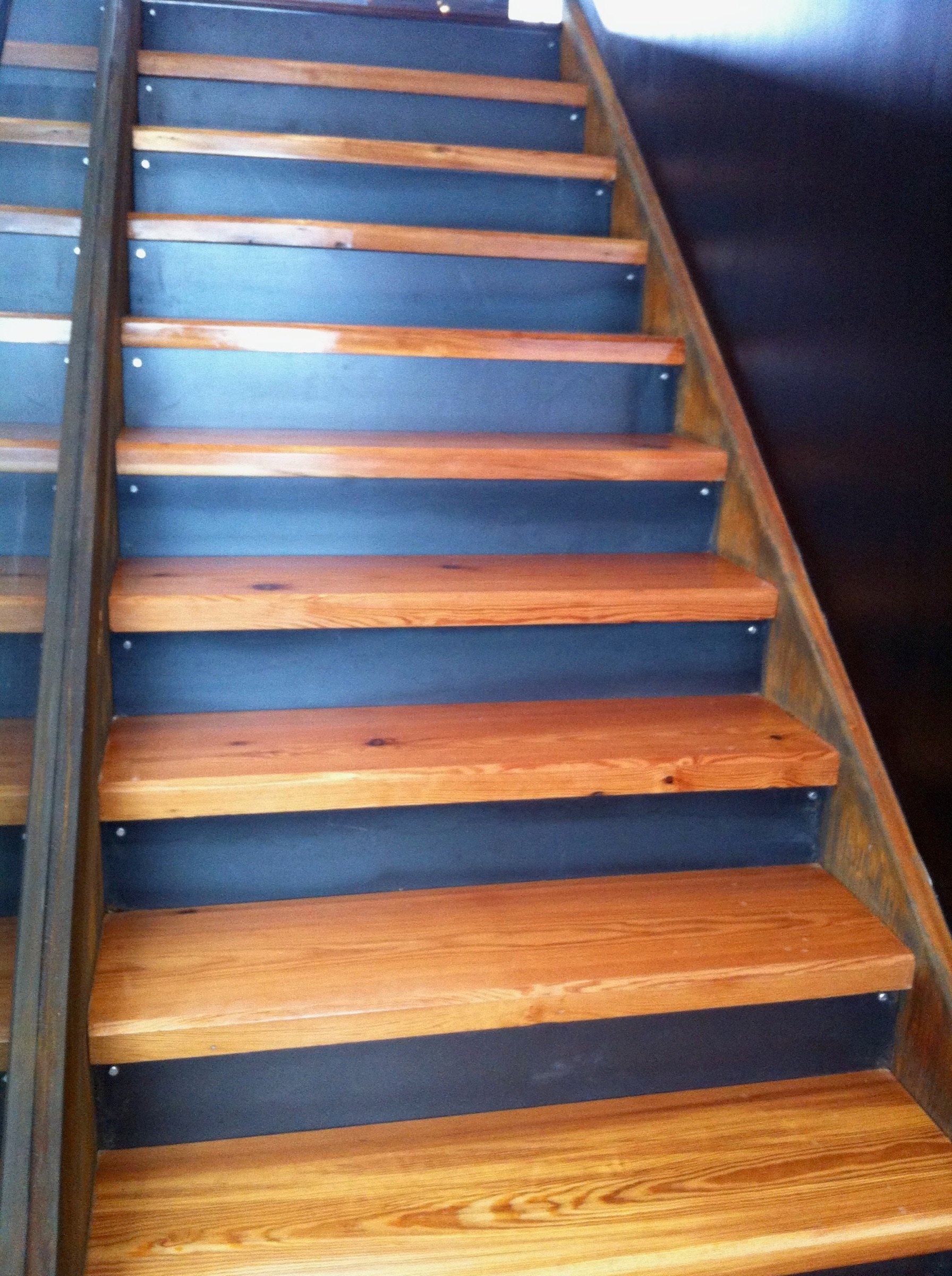 Front view of the open-riser steel staircase with wood treads