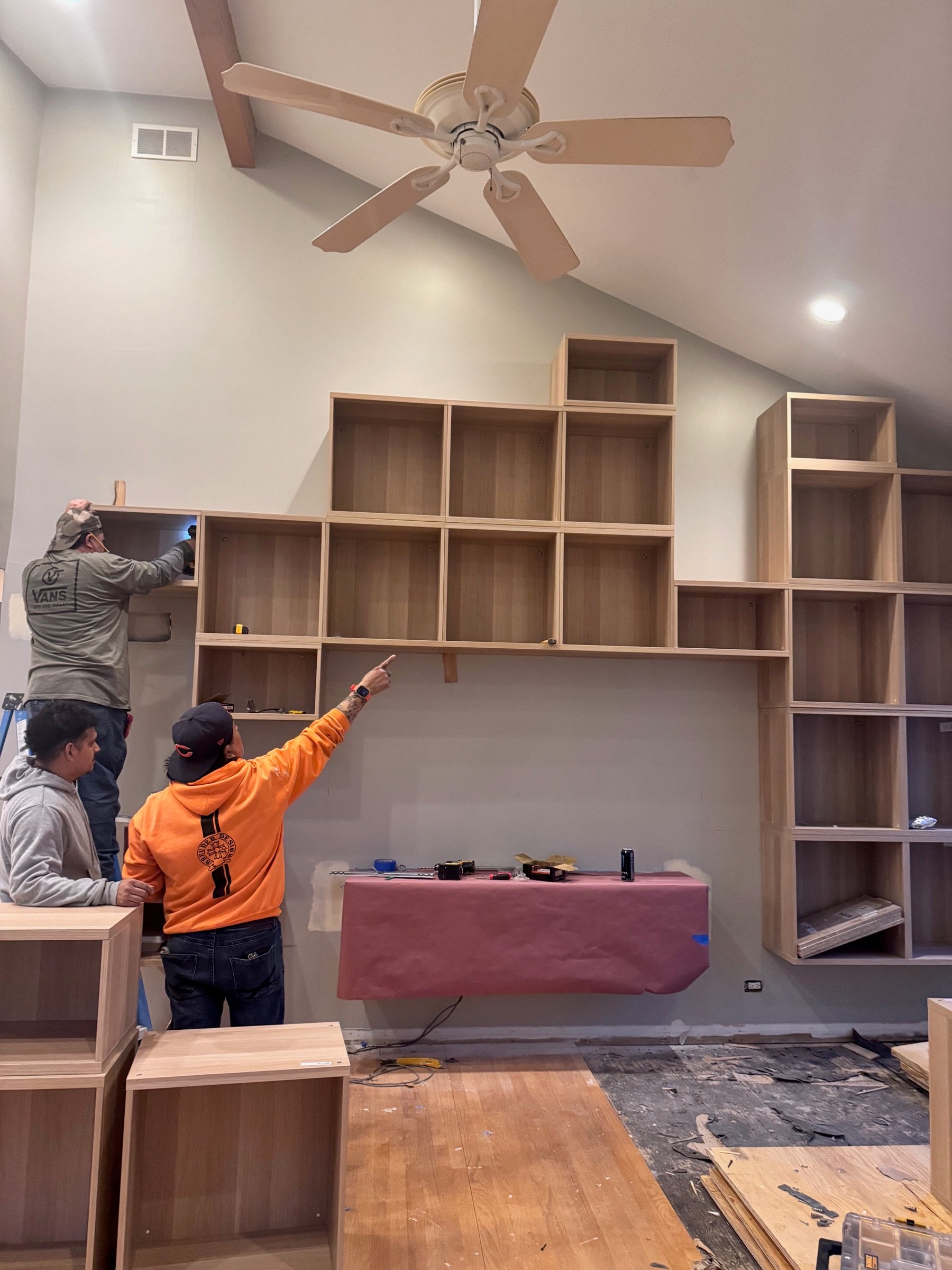 The crew installing custom built-ins — Robinwood residence